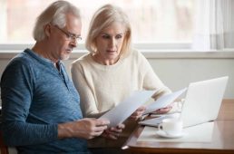 Serious worried senior couple calculating bills to pay or checking domestic finances stressed of debt, retired elderly old family reading documents concerned about loan bankruptcy money problems